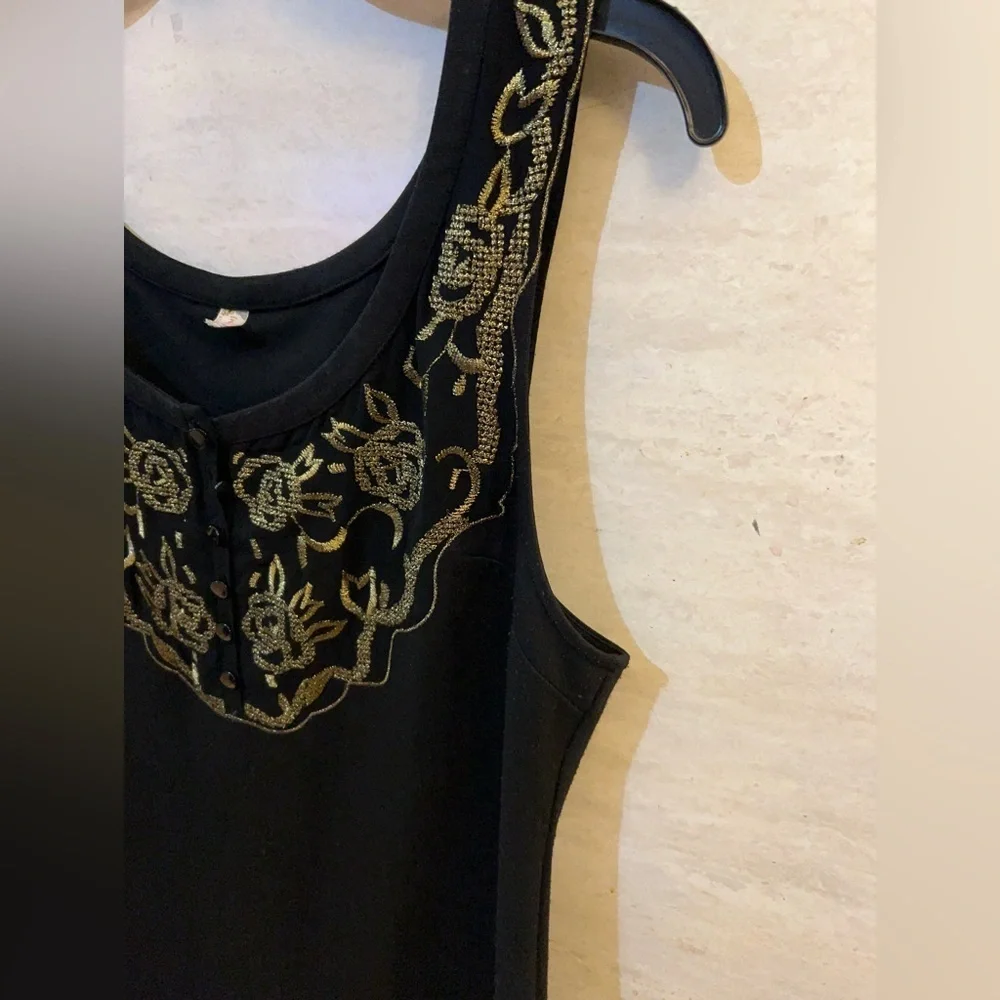 Free People sleeveless black dress with gold metallic embroidery.